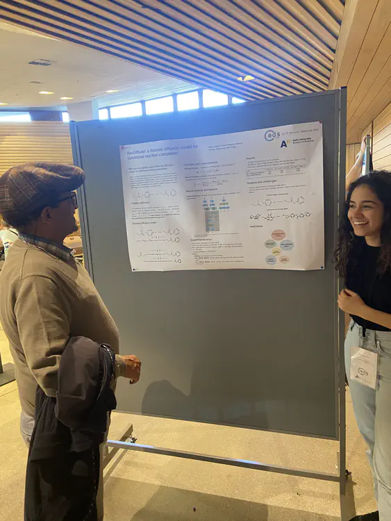 Najwa Laabid presenting a poster about an ongoing project on retrosynthesis.